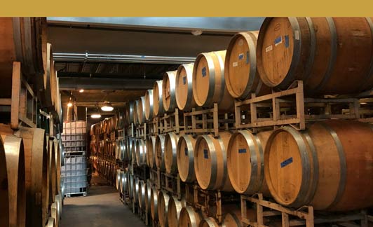 wine barrels at a winery in Pittsburgh who needs regulatory and compliance services