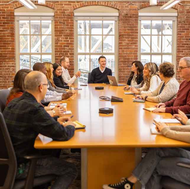 KrugerHenry sitting around conference table in Pittsburgh Office