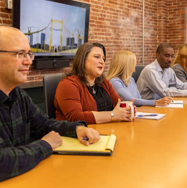 KrugerHenry Staff sitting at conference table